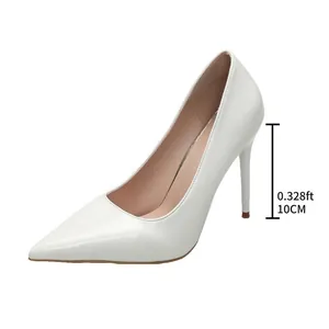 Detailed view of 10cm heel on white patent leather pointed toe stiletto pumps