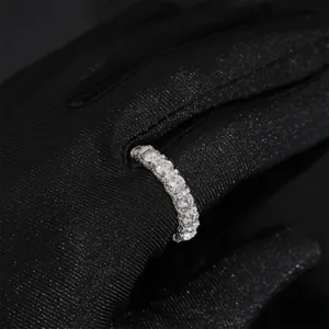 Stunning 925 silver eternity ring with 4mm round moissanite stones on black glove