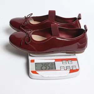 Product weight detail showing 295g for these burgundy patent leather Mary Jane flat shoes