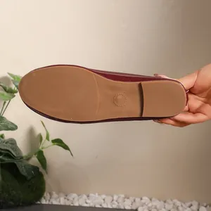 Detail view showing the non-slip rubber outsole of the burgundy ballet flat.