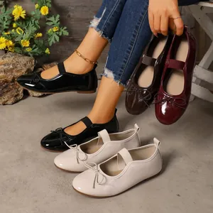 Elegant glossy patent leather women's ballet flats with bow detail and elastic strap