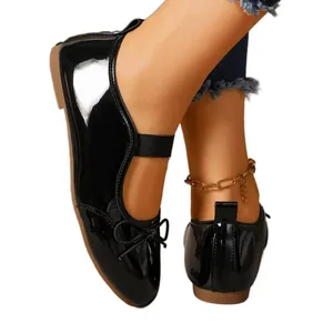 Elegant black patent leather ballet flats with bow and elastic strap for women
