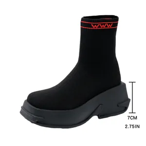 Detail view of black knit sock boot with a 7cm thick platform sole and red accent.