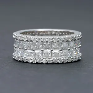 Detail view of 925 sterling silver ring featuring channel set princess cut moissanite stones