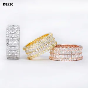 Detailed view of three hip hop style eternity rings with princess cut stones