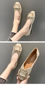 Detail of beige flat loafers with ornate gold square buckle and BONNICO branding