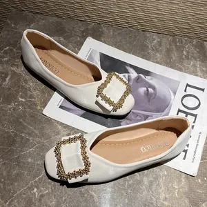 Elegant cream-colored square-toe ballet flats with decorative gold buckle