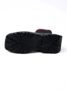 Bottom view of thick textured rubber sole on breathable black knit sock boots
