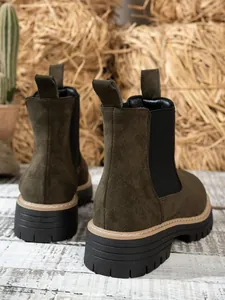 Back view detail of olive green suede platform Chelsea boots with thick lug soles