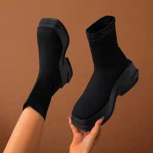 Detailed view of women's black breathable knit sock boots with chunky platform soles