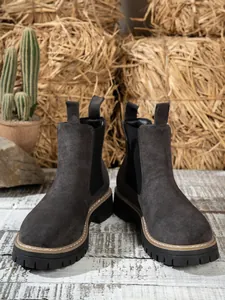 Frontal view of dark grey suede Chelsea boots with a rugged chunky platform rubber sole