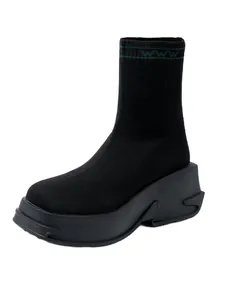 Detailed side view of black knit sock boot featuring a chunky platform sole and breathable fabric