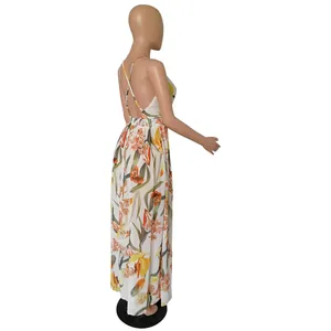 Side view of a white floral chiffon maxi dress featuring a backless criss-cross design.