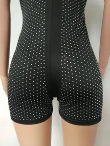 Close-up of black sleeveless bodycon romper with sparkling silver rhinestone detailing