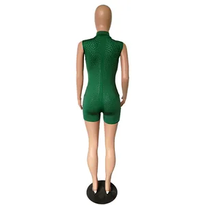 Back view of green sleeveless rhinestone jumpsuit on mannequin showing back zipper detail