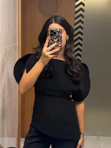 Chic women's black short sleeve top with dramatic asymmetric puff sleeves and slim fit