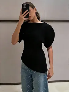 Model wearing a black asymmetrical puff sleeve slim fit t-shirt in a mirror selfie.