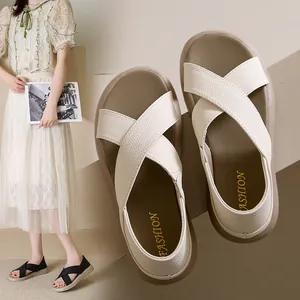 Lightweight summer flat sandals with cross-strap design and comfortable sole in beige.