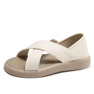 Comfortable women's cross-strap sandals in beige and tan with a soft pebbled leather finish