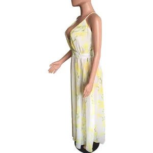 Side view of white chiffon maxi dress with yellow floral print and deep V-neckline