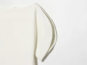 Close-up detail of the stylish white bubble sleeve on an asymmetric women's T-shirt