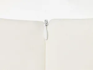 Macro view of the high-quality invisible zipper on a white slim-fit short-sleeved top