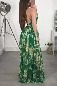 Detailed back view of a green floral chiffon maxi dress with backless design and floral print