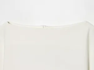 Detail shot of the elegant boat neckline with hidden zipper on a white slim-fit top