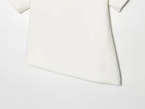 Macro view showing the white asymmetrical hem on a slim fit puff sleeve T-shirt