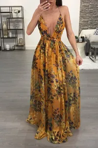 Deep V-neck floral chiffon maxi dress with backless design in a living room setting