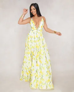 Detailed view of an elegant white maxi dress with yellow floral patterns and deep V-neck.