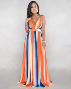Full view of vibrant orange and blue striped deep V-neck chiffon maxi dress on a model