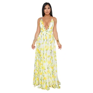 Elegant floor-length white chiffon maxi dress with vibrant yellow floral lily print.