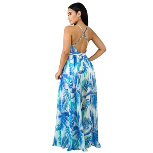 Back view of a tropical leaf print chiffon maxi dress with criss-cross straps.