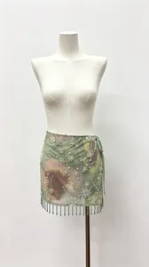 Detailed view of floral beach vacation mini skirt with sequins and beaded fringe