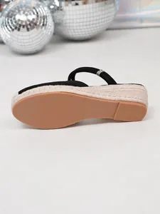 Gedetailleerd onderaanzicht van zwarte espadrilles met gevlochten jute tussenzool