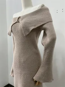 Detail view of elegant off-shoulder knit dress with large lapel and flared sleeves