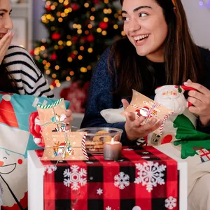 Due persone che condividono scatole regalo di Natale in kraft in un clima festivo