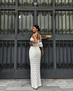 Elegant wit tweedelig gebreid setje met schubbenrok en witte crop top op een model