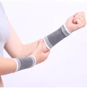 Close-up view of breathable grey striped sports wristbands worn on both arms for protection
