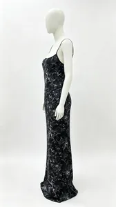 Side view of a black floral slip maxi dress on a white mannequin with thin straps.