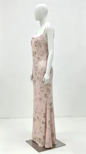 Elegant pink floral maxi dress with thin straps and corset style on a mannequin