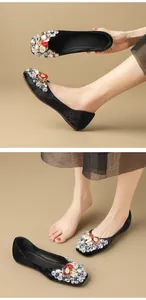Black velvet ballet flats with colorful crystal and rhinestone details shown on model feet