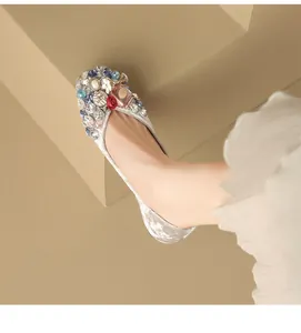 Detail view of luxury velvet flat with colorful rhinestone and pearl embellishments