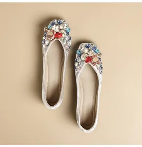 Top view of embellished silver velvet ballet flats with crystal and floral charms