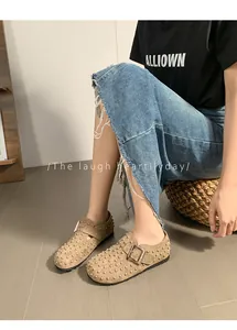 Vue détaillée de près de mules style Birkenstock kaki avec des clous et une boucle métallique.