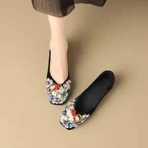 Elegant black velvet flats with vibrant crystal and bead floral embellishments for women.