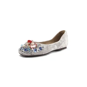 Elegant velvet flat shoes with colorful rhinestone and floral embellishments for women.
