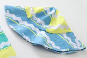 Close-up of kids' UV protective sun hat with blue and yellow wavy pattern