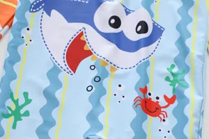 Detail of cartoon shark and crab print on boys quick dry UV protection swimwear